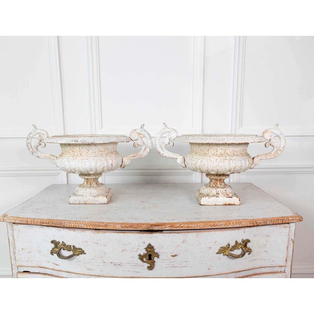 Made in England in the nineteenth century, this pair of cast-iron garden urns has twin scrolled handles and is finished in...