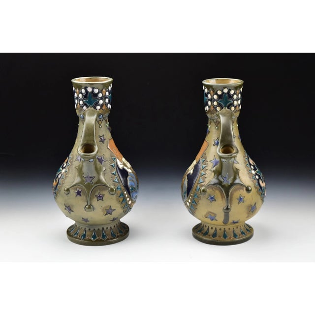 Rare pair of Imperial Amphora Austria Russian dignitary vases with open handles and painted with raised enamel. Impressed...
