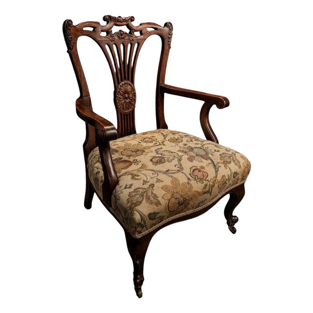 Victorian Carved Mahogany Armchair with Floral Upholstery and Brass Castors For Sale