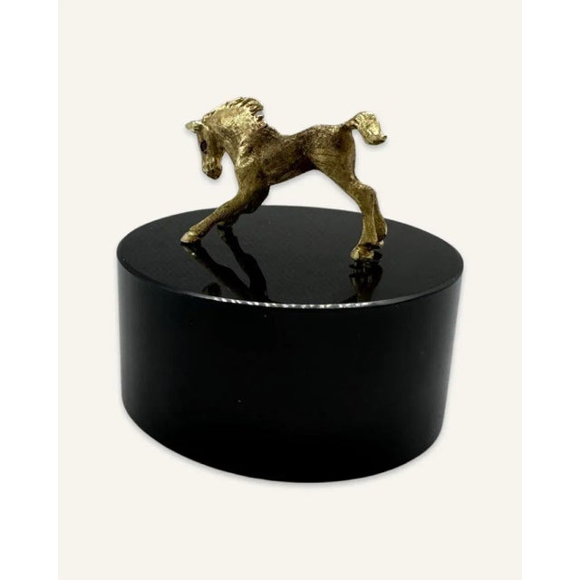 It’s hard to resist the appeal of this tiny gold foal. At 2,” it will fit just about anywhere. Cartier by the hallmark, it...