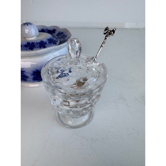 An exquisite sugar spoon adorned with a beautifully designed bow detail. Light gold wash on bowl.