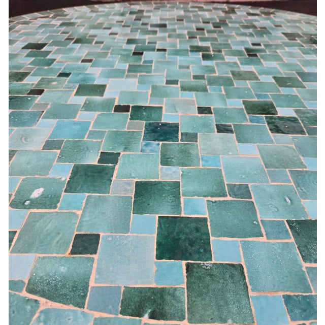 Beautiful handcrafted Moroccan mosaic table featuring an elegant emerald green color palette. Measuring 48 inches in...