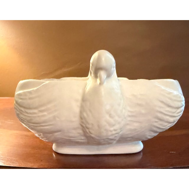 The Hull Pottery Open Rose Console Bowl with Dove Handles is a rare vintage piece from the mid-20th century, featuring a...