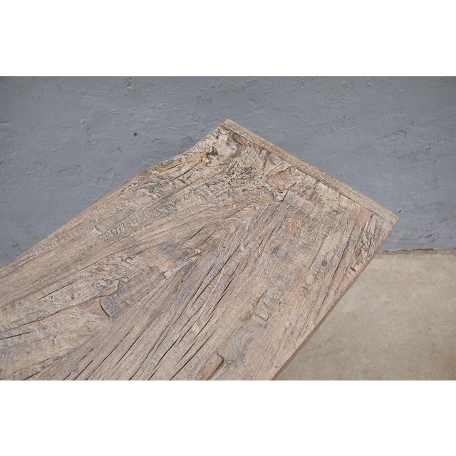 A beautifully rustic console table crafted from solid elmwood, dating to the 1st half of the 20th century. The long,...