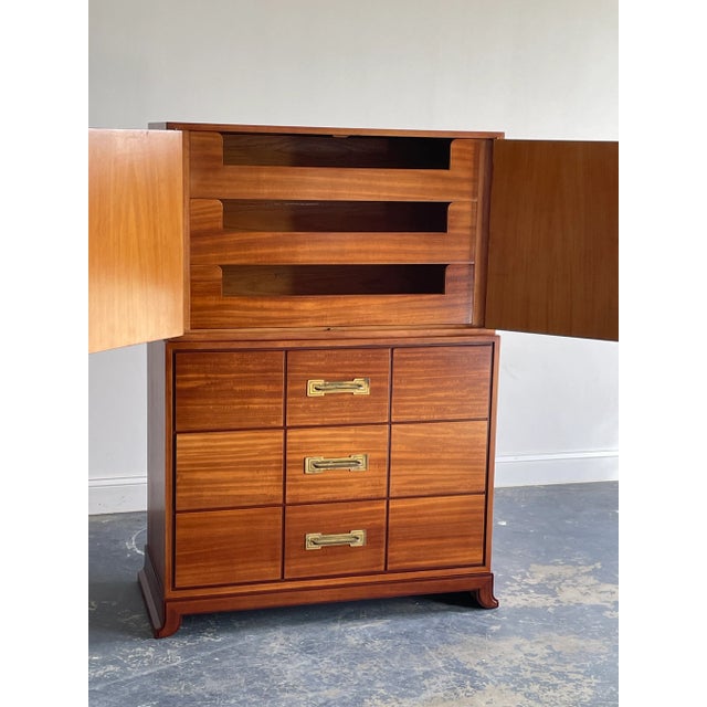 A tall chest of drawers designed by Tommi Parzinger for Charak Modern. Two piece cabinet with lower portion consisting of...