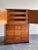 A tall chest of drawers designed by Tommi Parzinger for Charak Modern. Two piece cabinet with lower portion consisting of...