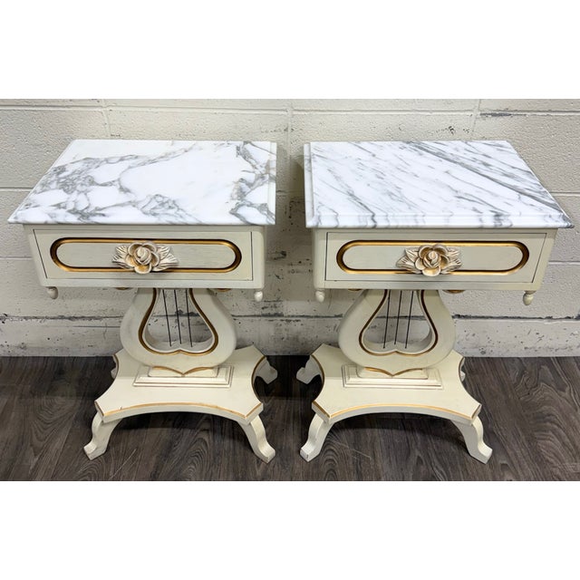 This is a gorgeous pair of vintage Hollywood Regency marble top nightstands featuring genuine white marble tops, carved...