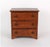 A small, plain Federal style oak chest of three drawers in a warm honey-brown finish with a plain overhanging top, simple...