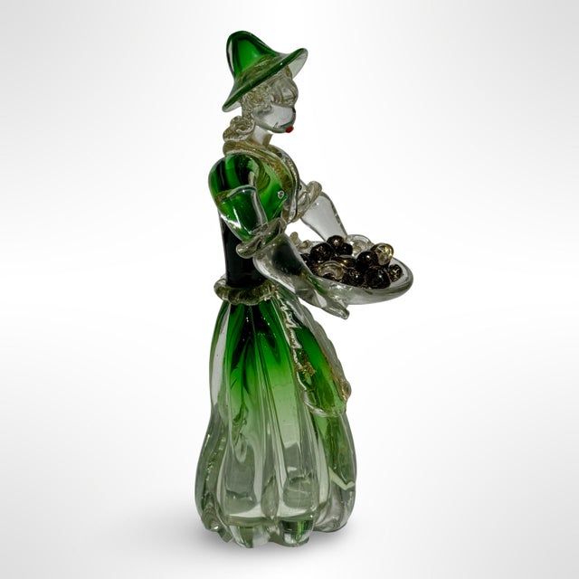 This vintage Murano style glass figurine depicts a finely detailed woman in a flowing emerald green dress and matching...