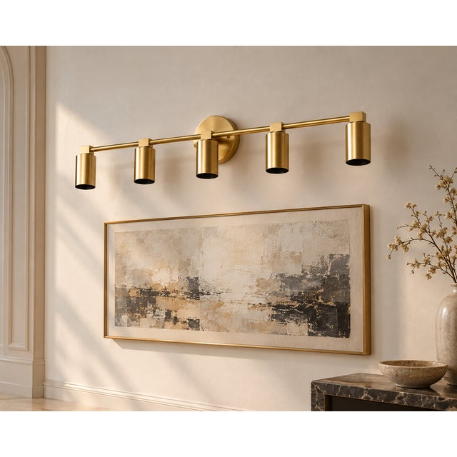Bring a clean architectural presence to a bathroom, dressing area, or interior wall with this handcrafted brass 5-light...