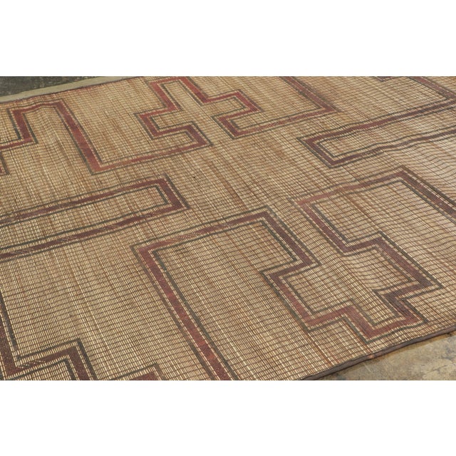 This vintage Moroccan mat is a primitive 6x7 Tuareg rug from the nomadic tribe of the same name. Handwoven with reeds and...