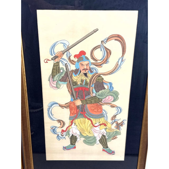 A pair of traditional Chinese Gongbi paintings on silk depicting elaborately dressed door guardian warriors. Featuring...
