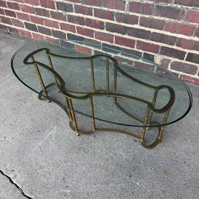 This is a stunning 1970s brass and glass Mastercraft Racetrack coffee table.