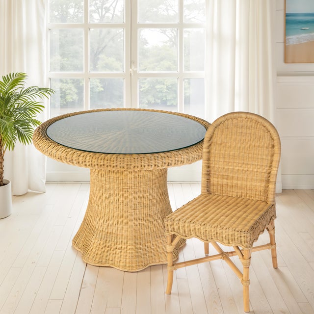 Effortlessly capturing coastal charm, the Butler Specialty Company Flora Rattan Dining Side Chair brings natural warmth...