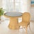 Effortlessly capturing coastal charm, the Butler Specialty Company Flora Rattan Dining Side Chair brings natural warmth...