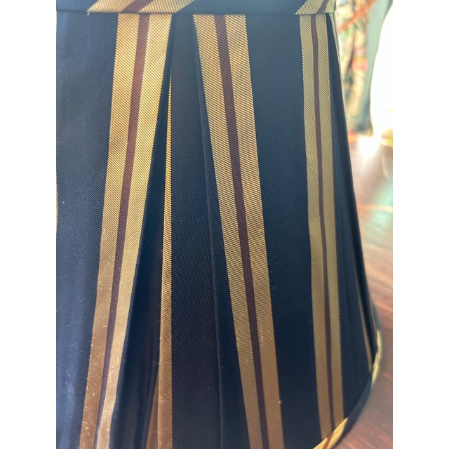 A lampshade handmade from a vintage necktie silk. Measurements: top 7” bottom 14” side 11”