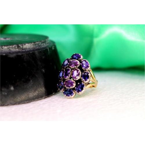 Gold and Silver Ring with Twelve Amethysts Inlaid, in Very Good conditions. Designed 1980 to 1989 This piece has an...