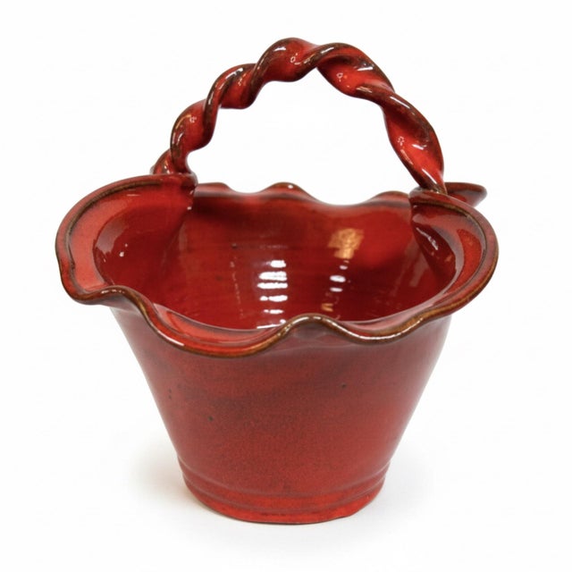 A striking signed Owens Pottery basket from North Carolina, dated 1998. This hand-thrown pottery basket features a rich...
