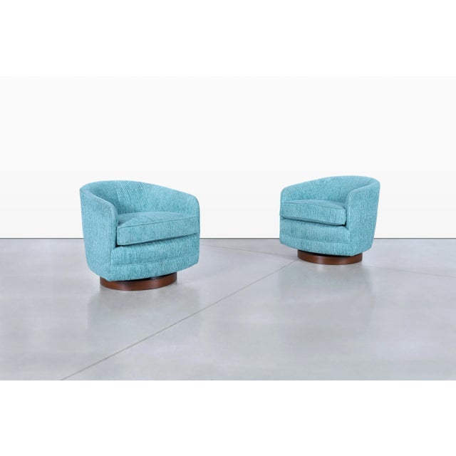Imagine adding a touch of mid-century elegance to your space with these stunning vintage walnut swivel lounge chairs,...