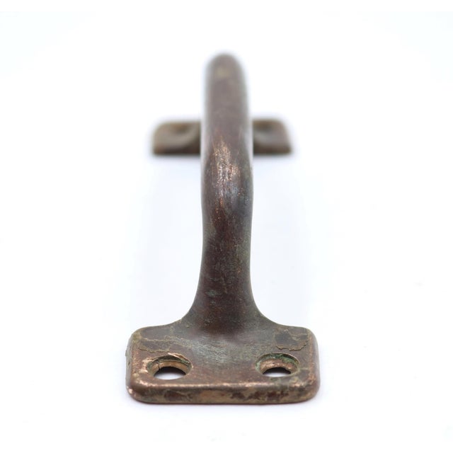 Classic style brass bridge lift pull that could be used on furniture or windows. The original mounting screws are not...