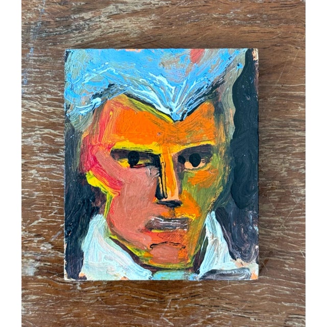 This painting bursts with raw, expressive energy. A face, sculpted out of thick impasto, commands the canvas with piercing...