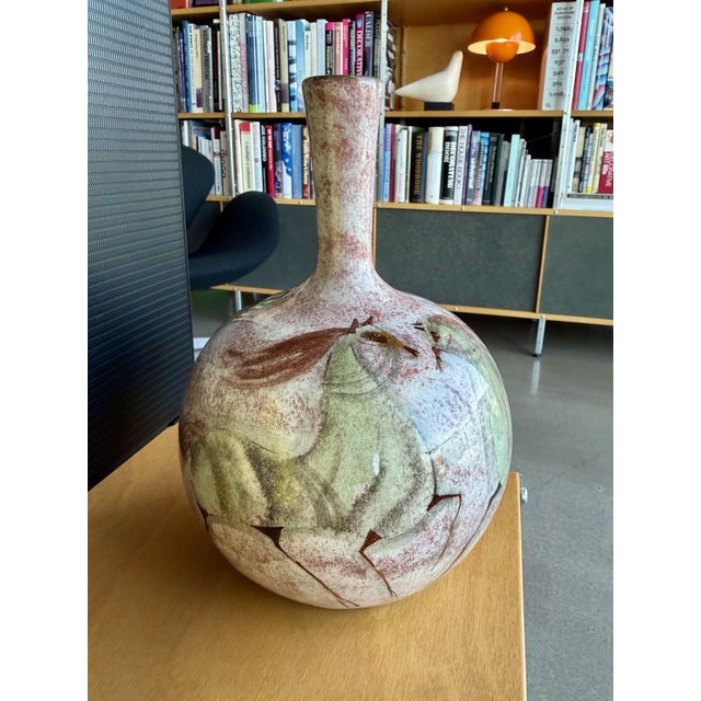 This mid-century studio art pottery bottle vase was designed and handmade by ceramicist Polia Pillin circa 1950. Crafted...