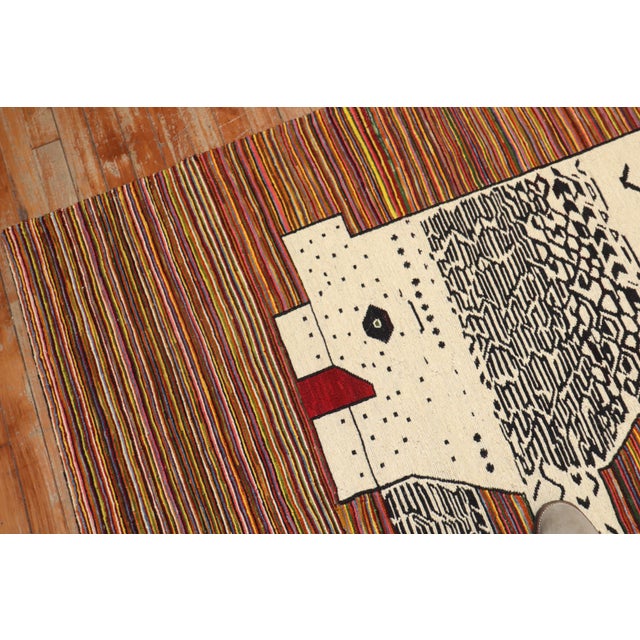 Accent size Persian kilim from the late 20th century with a lion on a striped field Measures: 4'9'' x 7'7''. This was...