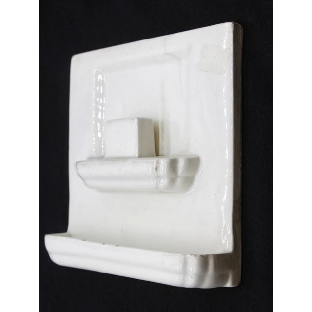 White ceramic tile with a 3D design and a shiny crackled glaze. There are some chips on the back. Please see the photos....