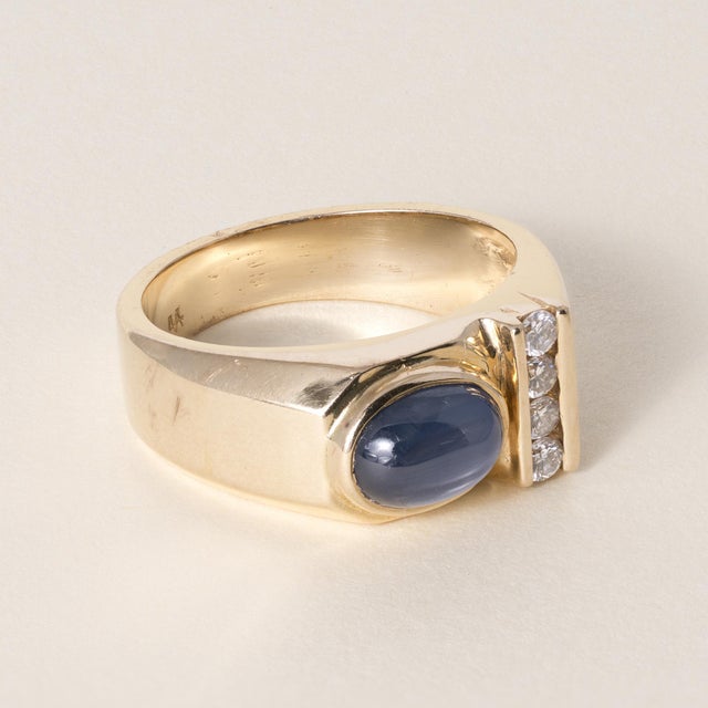 Vintage Sapphire & Diamond Ring 14K Gold Circa 1980 A vintage design featuring a rich blue oval cabochon sapphire set in...