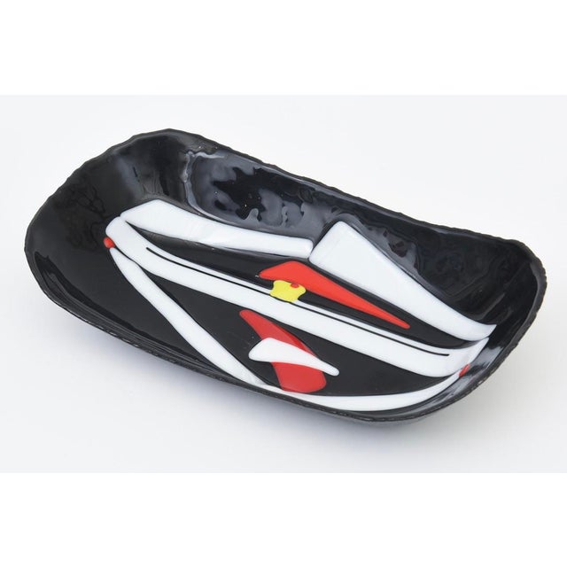 This vintage black glass pop art fused glass bowl is from the 1970's. It is very mod looking with it's graphic details and...