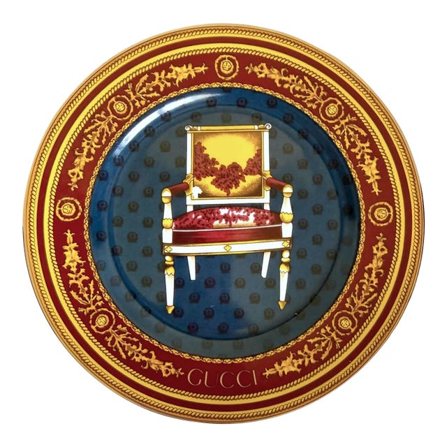 Here is a fabulous vintage Gucci Porcellana decorative plate featuring an ornate neoclassical chair motif surrounded by...