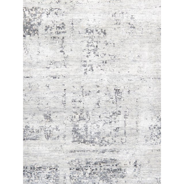 The Modern Collection explores hand-knotted design through abstract patterning, solid tonal fields, and subtle surface...