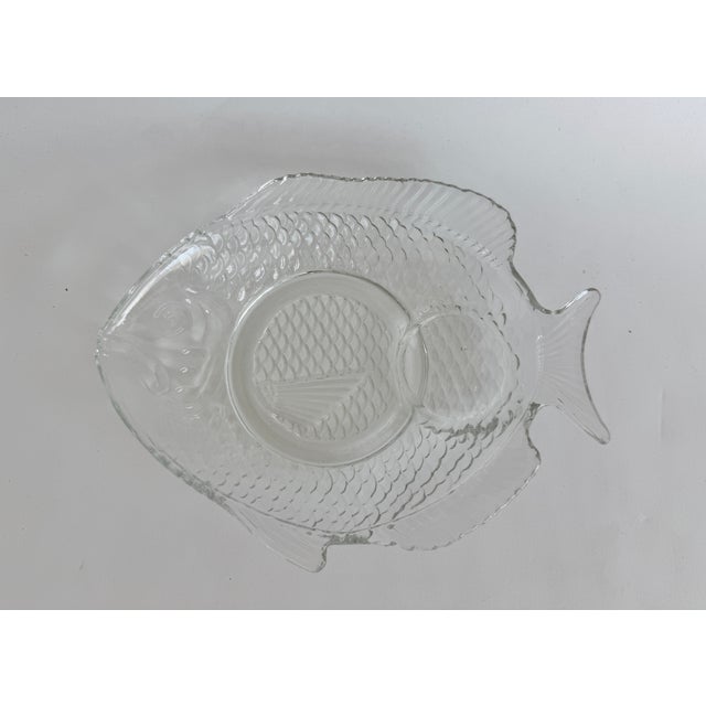 A set of four Arcoroc France mid-century glass plates in a distinctive fish shape with a textured scale pattern on the...