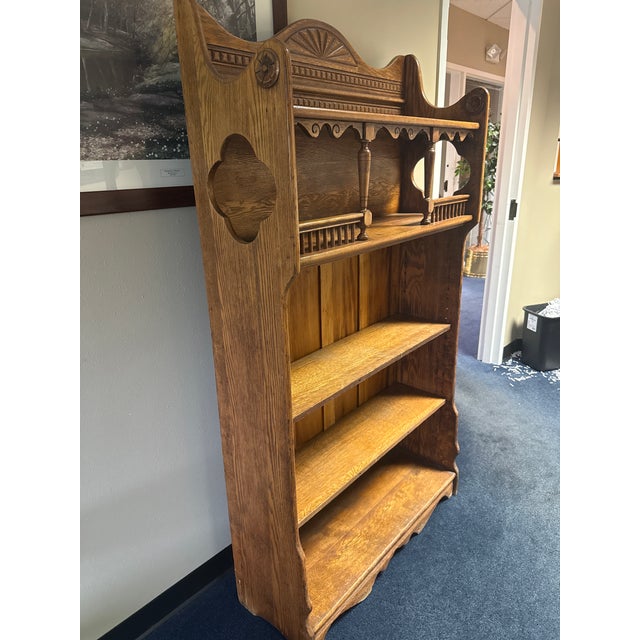 Ornate antique Victorian bookcase is constructed from solid oak with a warm medium-brown finish. This piece has a...