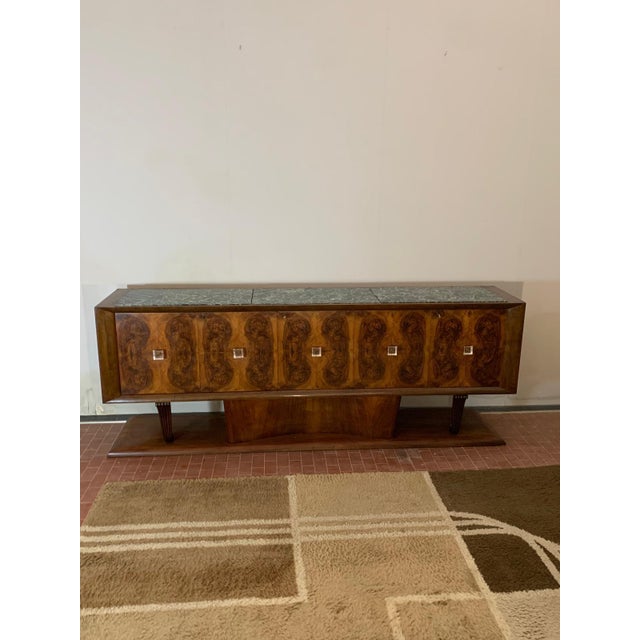 Art deco sideboard of excellent carpentry and made with quality materials. On the base rests the central rounded body on...