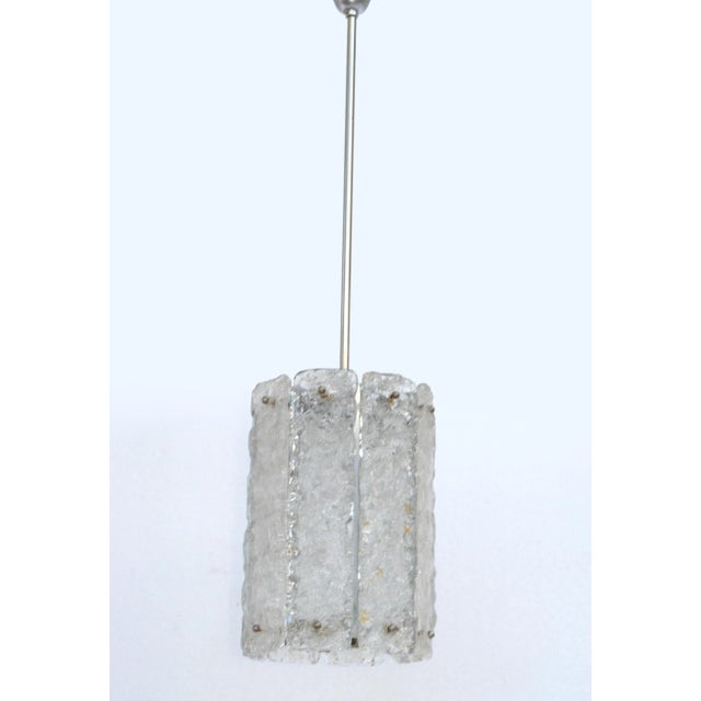 Kalmar ice 1 Light Pendant Lamp or Chandelier in Chrome and Panels of Crystal Glass. The Socket is made out of porcelain....