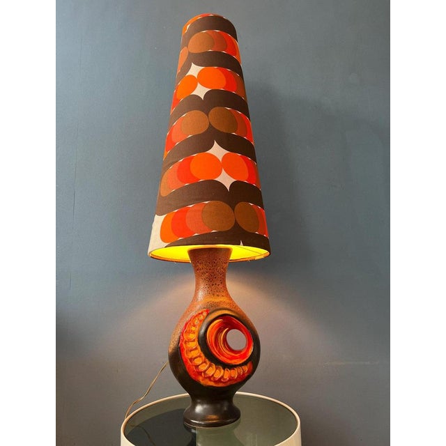 Red orange west germany space age floor lamp with ceramic base and dotted textile shade. The piece has two lightsources:...
