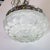 Floral motif molded glass flush mount ceiling fixture with nickel hardware.