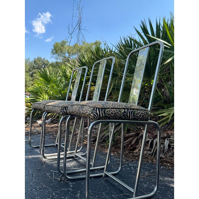 A striking set of three postmodern side chairs designed by François Arnal for Atelier A, showcasing sleek polished chrome...