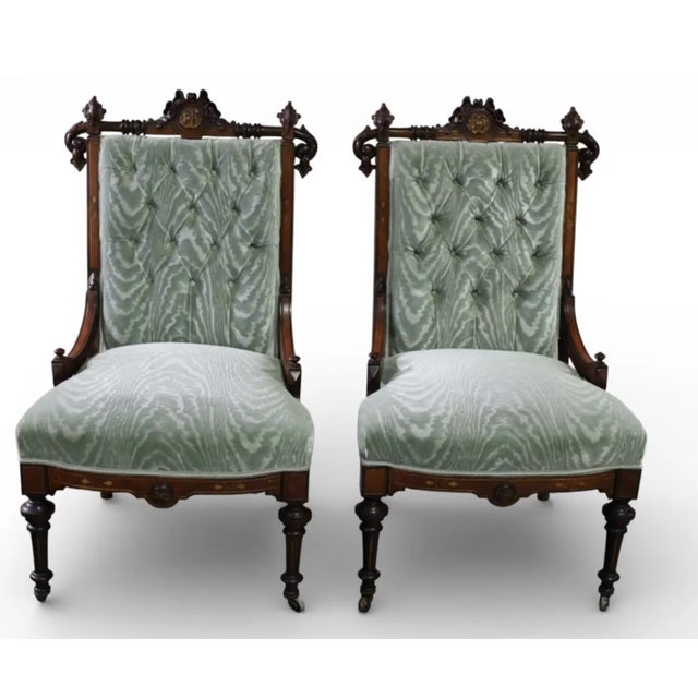 Gorgeous pair of antique Victorian rosewood parlor chairs. They feature intricate relief carving, turned front legs fitted...