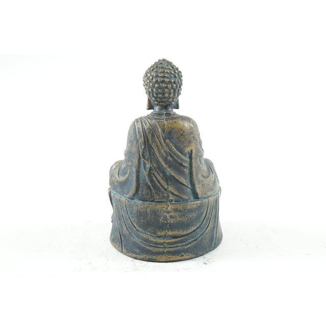 This is an Antique Chinese Bronze Buddha Statue, measuring 5” x 4” x 9”, featuring a serene depiction of Buddha seated in...