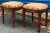 This is a pair of French style carved fruitwood ottomans in leopard needlepoint. They date to the later part of the 20th...