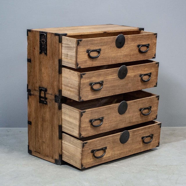 Early 1900's Japanese kimono chest made in two sections of kiri wood (paulownia). The four drawers slide easily and...