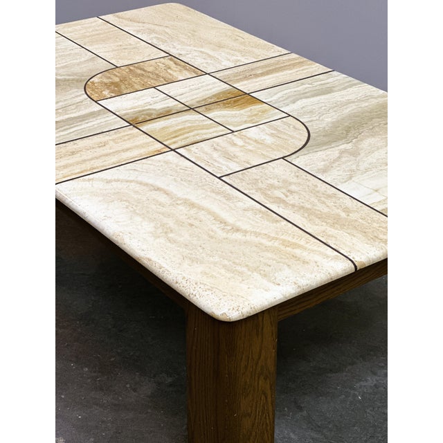 Impressive large coffee table dating from the 1970s, featuring a beautifully tessellated travertine stone top with an...