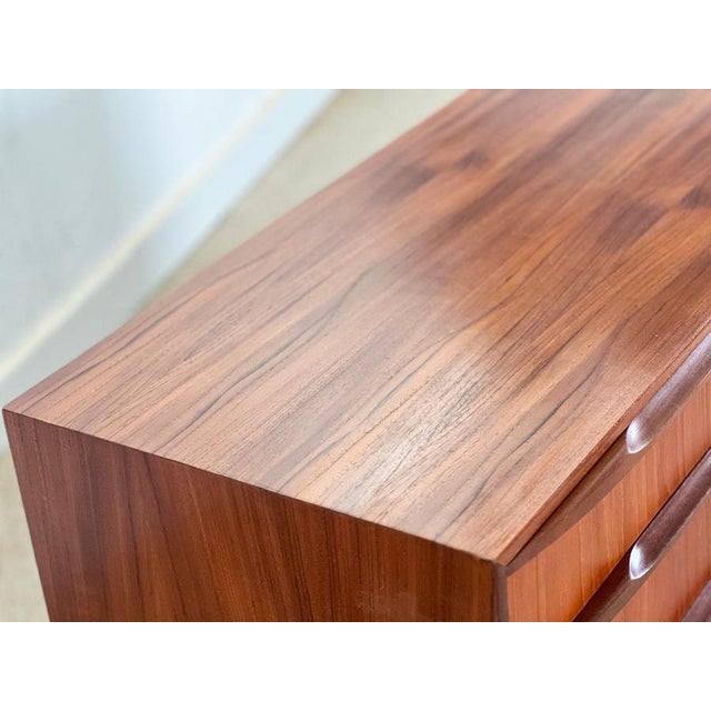 A beautiful creation of british mid-century design, this teak sideboard was conceived in the 1970s by renowned designer...