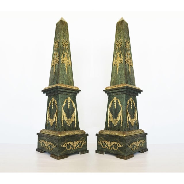 Pair of large marble obelisks. Made from solid Verde Antico marble with bronze neoclassical style decorative mounts on all...