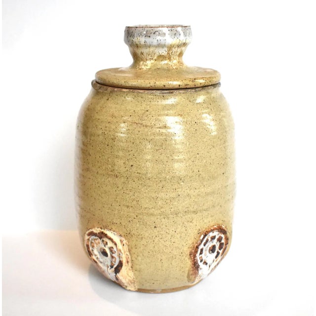 A vintage, mid-century studio or art pottery lidded jar with medallion details, signed Dave Kohl and dated 1970.