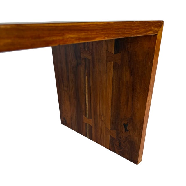 This vintage mid-20th century waterfall coffee table is constructed of solid, beautifully figured rosewood. The sides are...