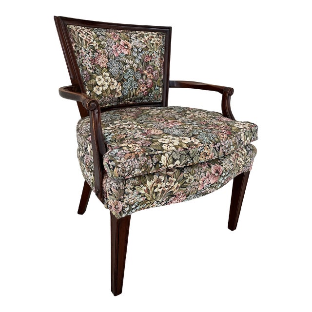 Beautiful French Bergere chair in vibrant multicolor floral upholstery. Dark-stained mahogany wood carved arms, back, and...