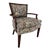 Beautiful French Bergere chair in vibrant multicolor floral upholstery. Dark-stained mahogany wood carved arms, back, and...